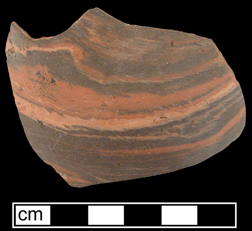 Biscuit fired thrown agateware sherd in unidentified hollow form, probably a teapot or jug.  This waster sherd is comprised of the blending of three different clay colors and was discarded prior to glazing - Agateware was one of the first earthenware ceramics to be fired twice: the first firing produced an unglazed, biscuit-fired vessel, which was then glazed and fired a second time - Collected by George L. Miller in 1986 in Staffordshire in Hanley.  Cannot be attributed to a specific pottery. 